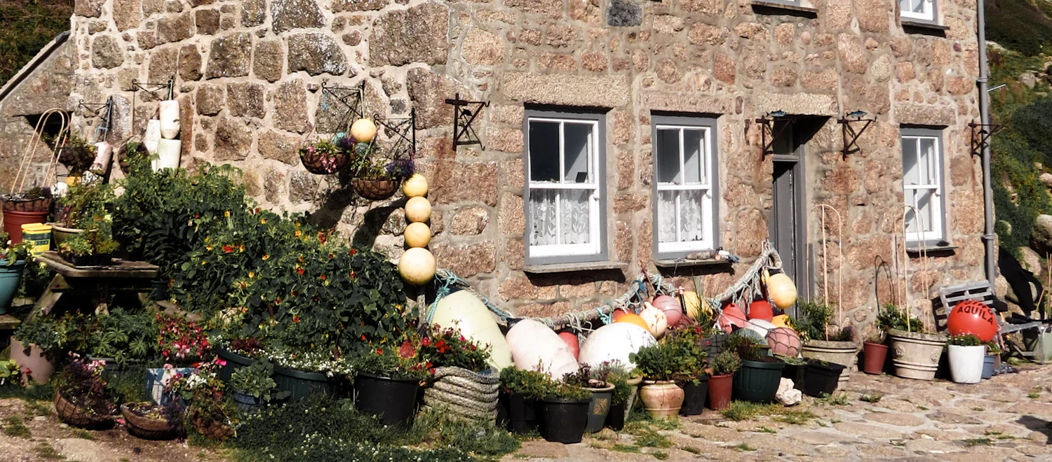 A stone cottage with a garden